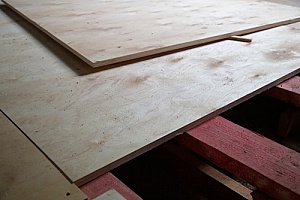sheets of plywood being used in a building