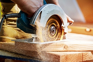 Saw cutting into wood