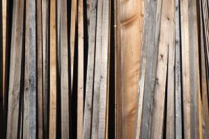 Stack of weathered planks. The main benefit of copper azole treatment is that it extends the longevity of the lumber