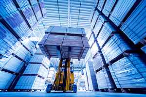 Forklift loader in storage warehouse of wholesale lumber supplier