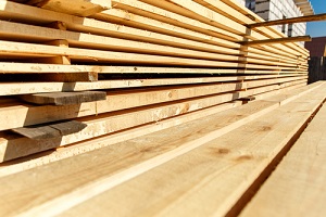 stack of new wooden studs at the lumber yard