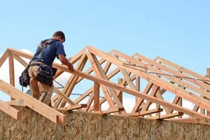 man preparing wood roof