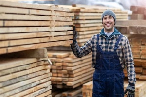 smiling worker in lumber yard