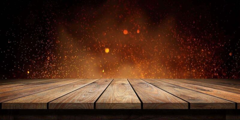 wood table with flame effect on dark background